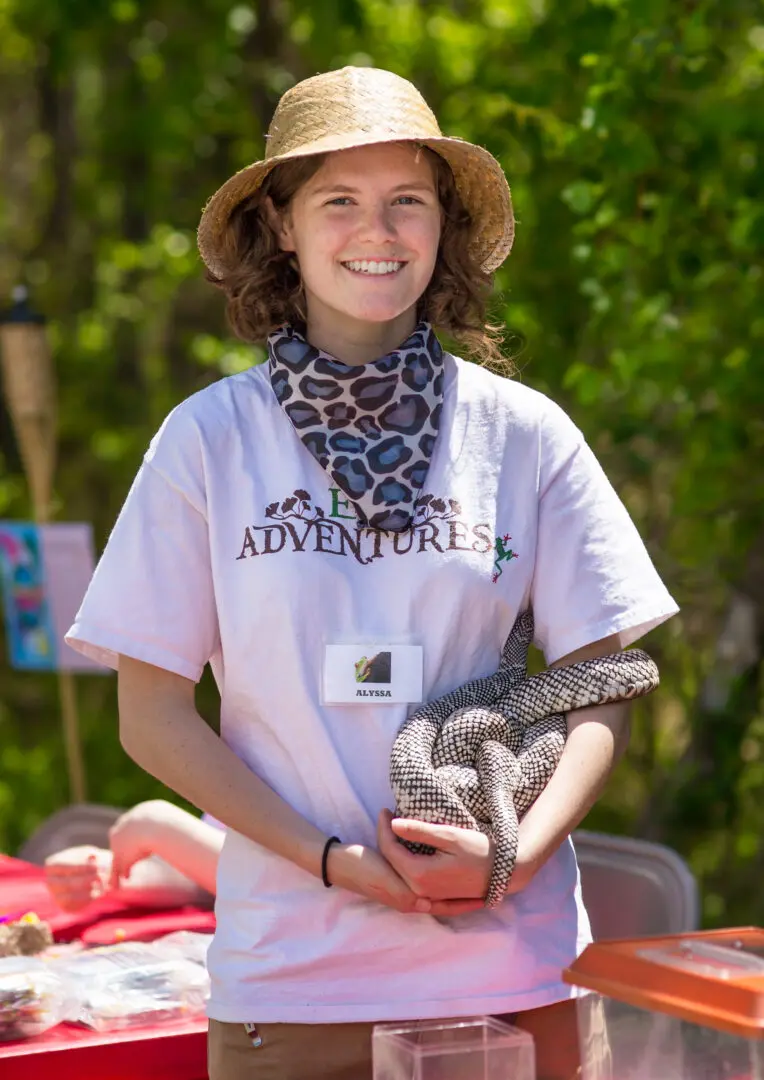 A woman holding an animal in her hands.