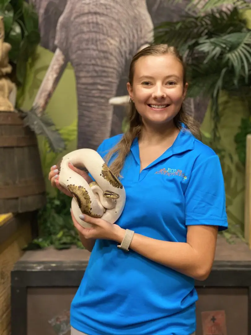 A woman holding a snake in her hands.