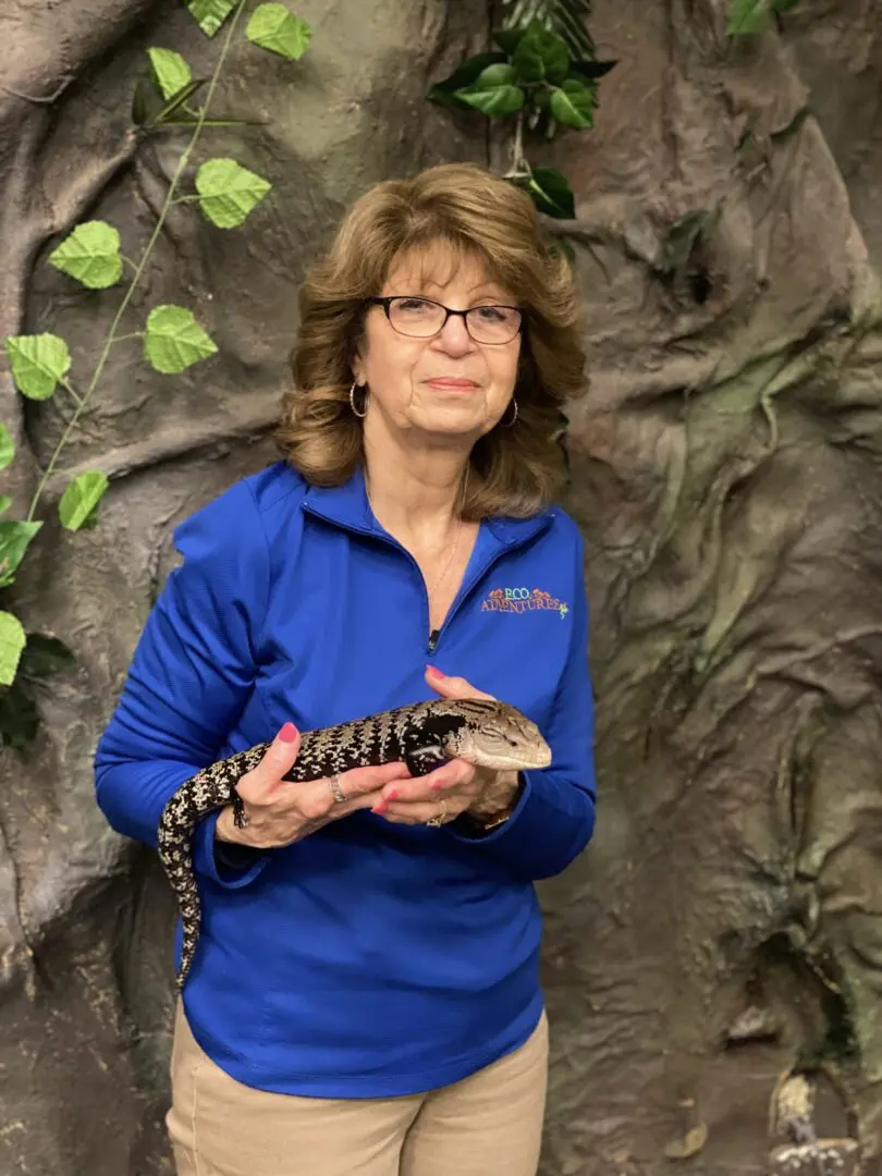 A woman holding an animal in her hands.