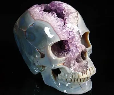 A skull with amethyst in the middle of it.