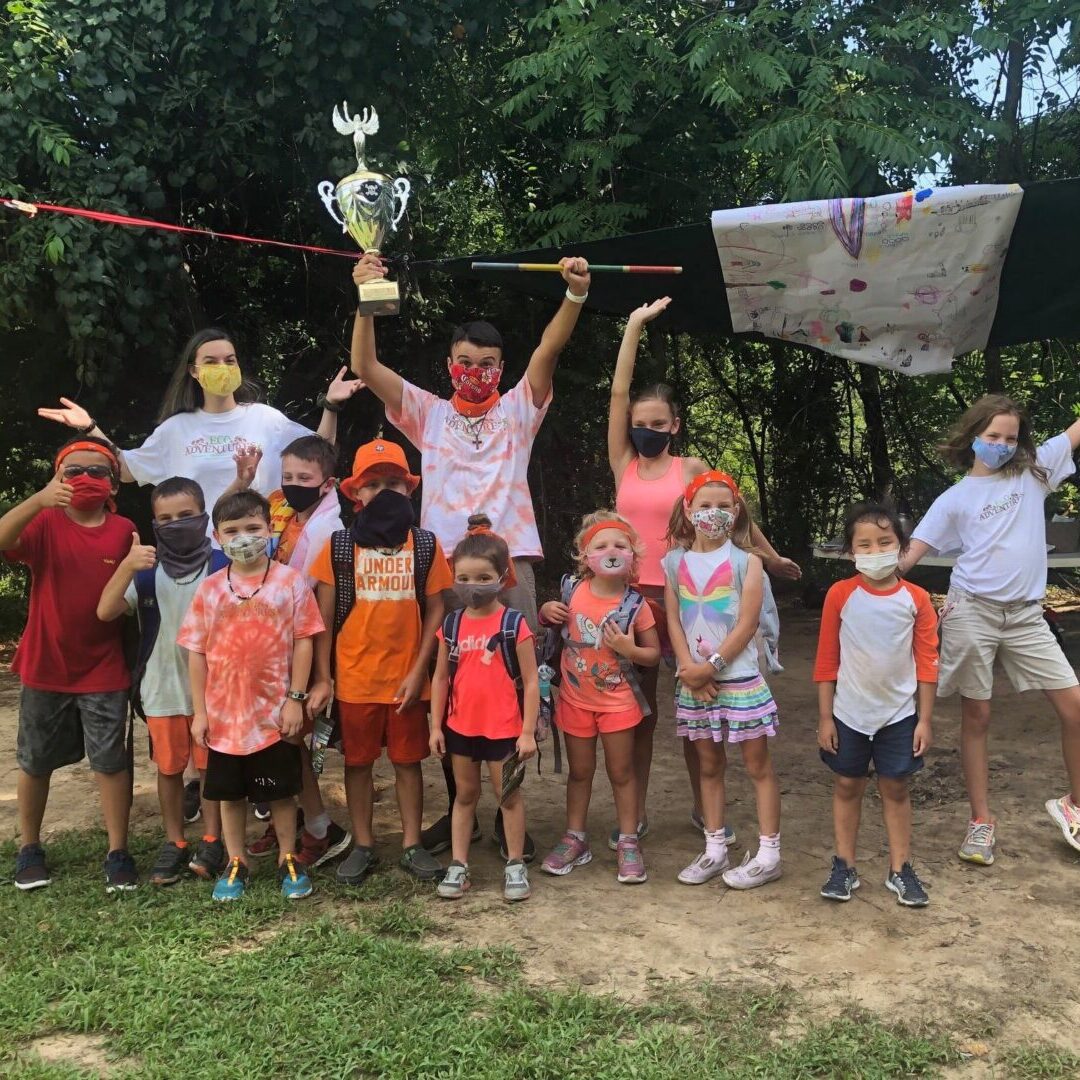 A group of people standing in the dirt.