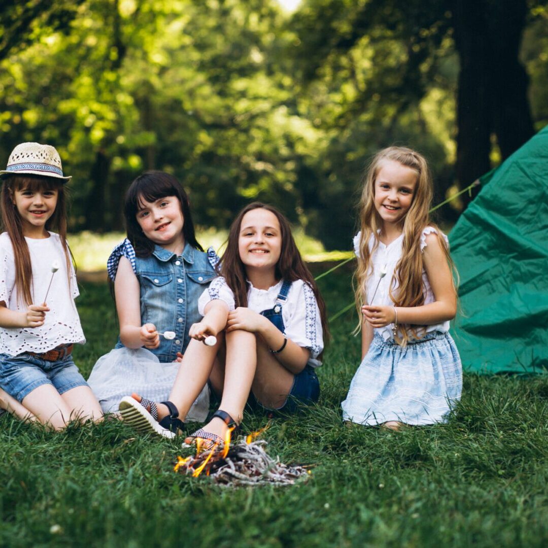 Group of girls tourists by the tent in forest