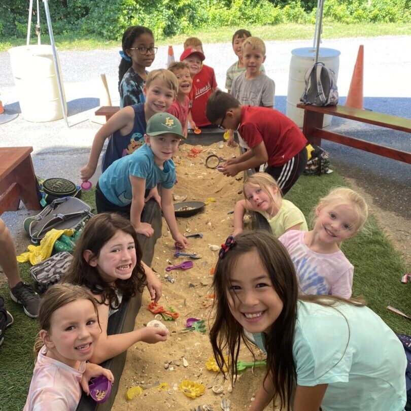 A group of children sitting around a table.