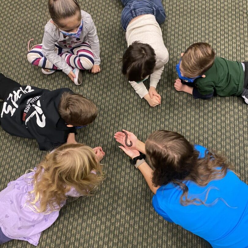 A group of children laying on the ground.