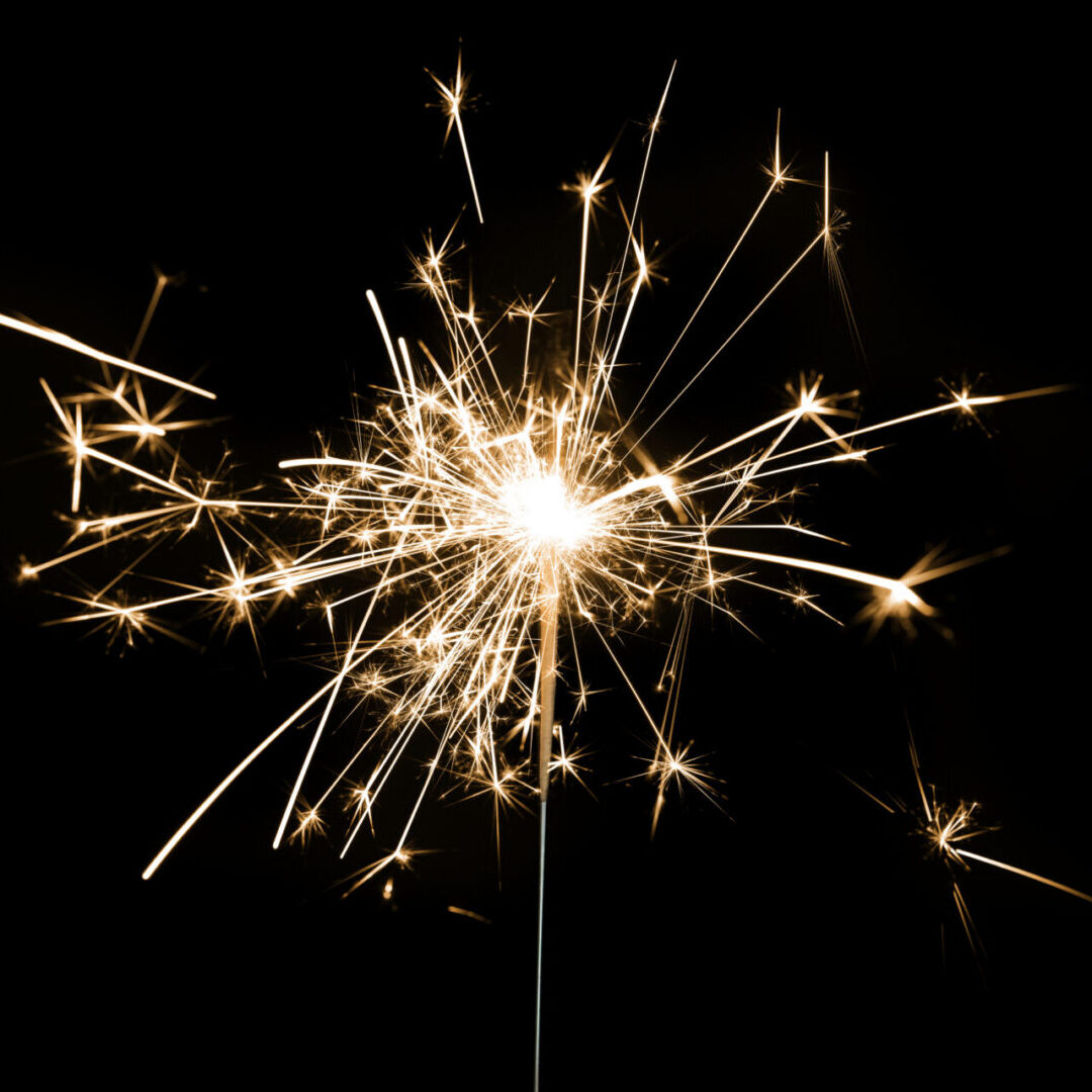 Burning sparkler on a black background wallpaper