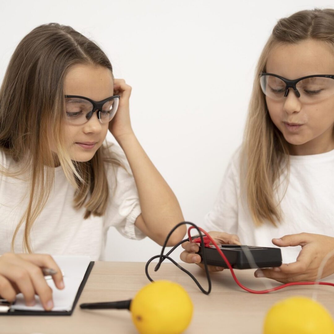 two-girls-doing-science-experiments-with-lemons-electricity